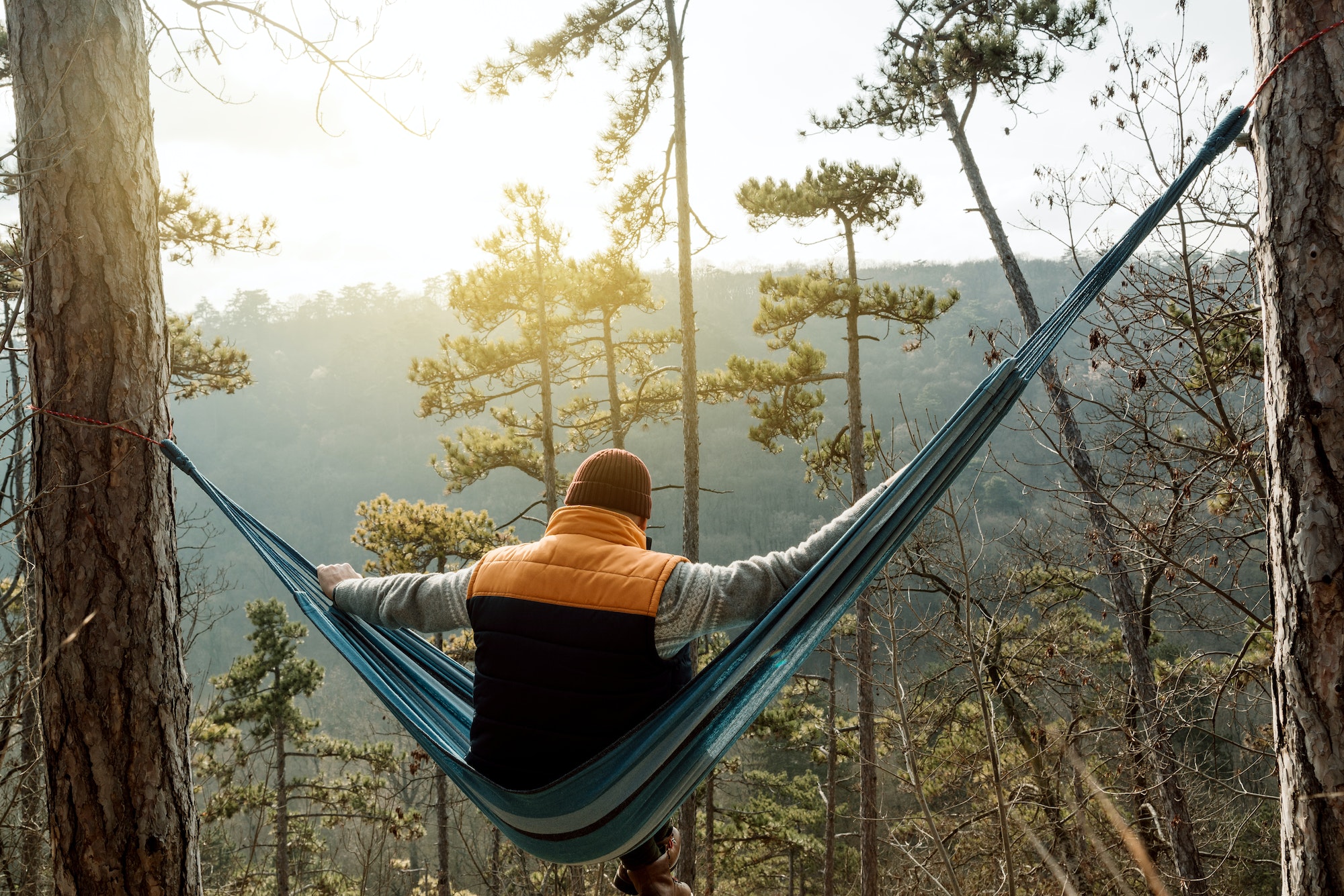 Young man resting in hammock, outdoor lifestyle